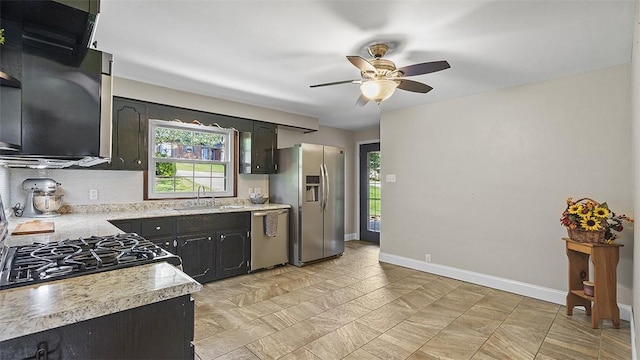 900 N Whitmore Rd, North Huntingdon, PA 15642 - kitchen with stainless steel appliances, light countertops, ceiling fan, and tasteful backsplash