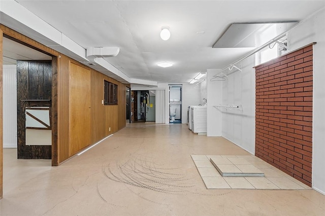 900 N Whitmore Rd, North Huntingdon, PA 15642 - hallway featuring washer / dryer, brick wall, and wood walls
