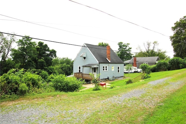 216 Duffy Dr, Moon/Crescent Twp, PA 15108 - back of house featuring a wooden deck, driveway, and a lawn