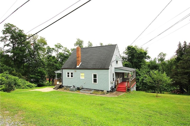 216 Duffy Dr, Moon/Crescent Twp, PA 15108 - view of side of property featuring a chimney, a lawn, a shingled roof, and view of wooded area
