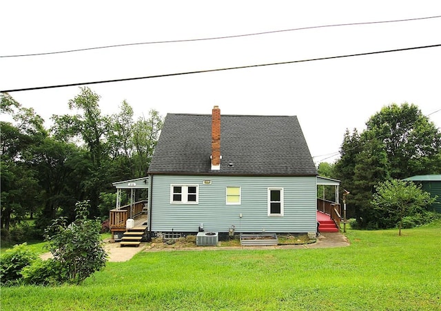216 Duffy Dr, Moon/Crescent Twp, PA 15108 - rear view of house featuring a chimney and a yard