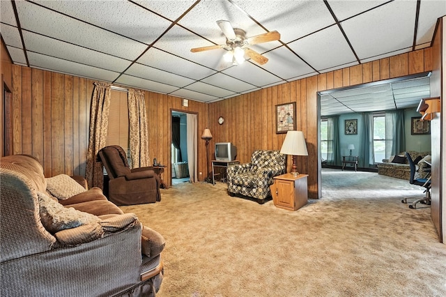 339 E Market St, Mercer Boro, PA 16137 - living area featuring carpet floors, wood walls, a ceiling fan, and a drop ceiling