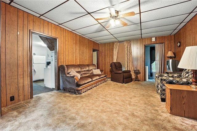 339 E Market St, Mercer Boro, PA 16137 - living room with wooden walls, carpet, a drop ceiling, and a ceiling fan