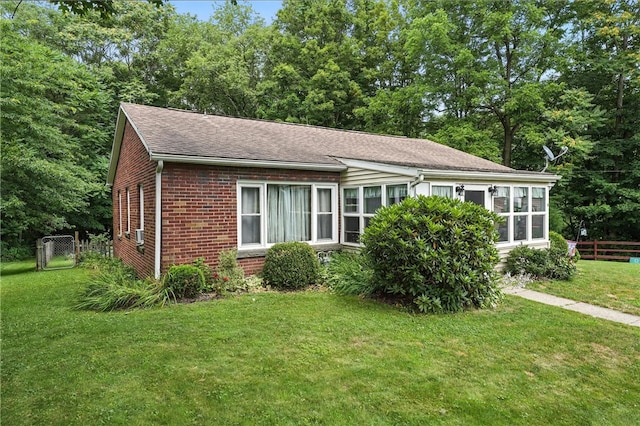 231 E N St, Mercer Boro, PA 16137 - view of front facade with brick siding and a shingled roof