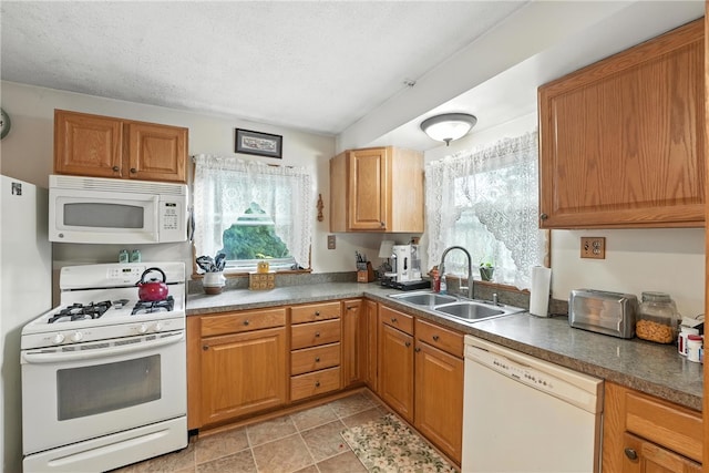 231 E N St, Mercer Boro, PA 16137 - kitchen with white appliances, plenty of natural light, dark countertops, and brown cabinets