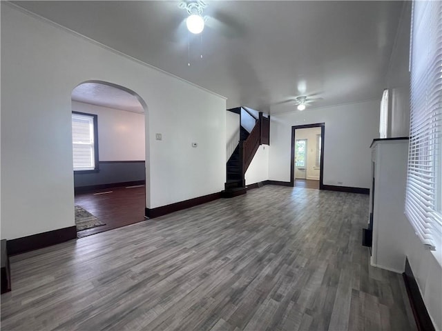 721 Center Ave, City Of But Se, PA 16001 - empty room with ceiling fan, dark wood-style floors, stairs, and arched walkways