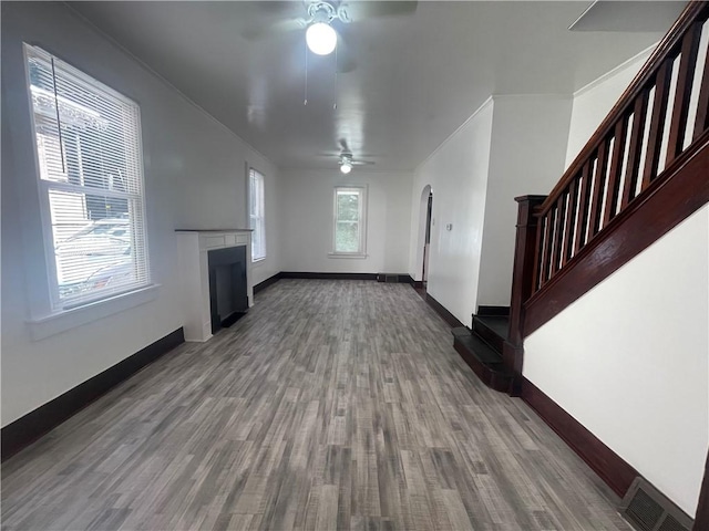 721 Center Ave, City Of But Se, PA 16001 - unfurnished living room featuring a ceiling fan, a fireplace, and wood finished floors