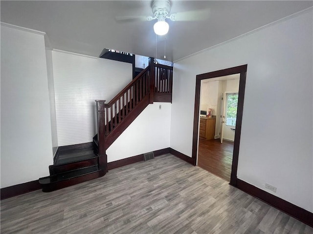 721 Center Ave, City Of But Se, PA 16001 - stairs with wood finished floors, ceiling fan, and crown molding