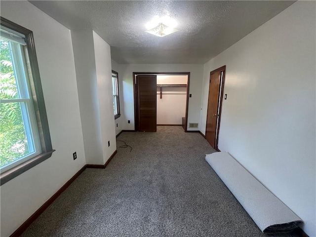 721 Center Ave, City Of But Se, PA 16001 - corridor featuring a textured ceiling, healthy amount of natural light, and carpet flooring
