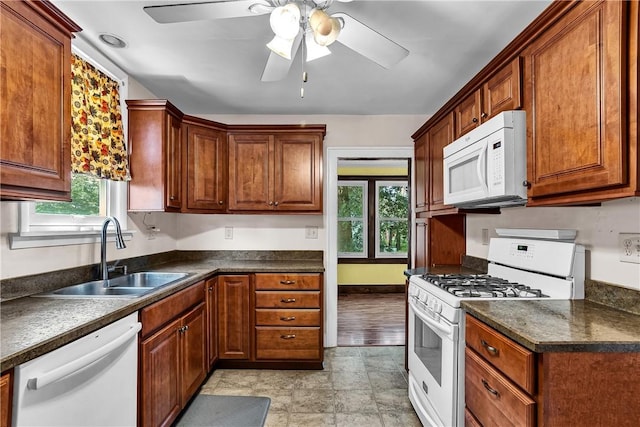 200 38th St, Beaver Falls, PA 15010 - kitchen with white appliances, dark countertops, a ceiling fan, and brown cabinets