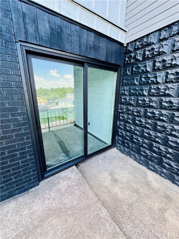 26 Wilmac St, South Union Twp, PA 15401 - doorway to property with brick siding