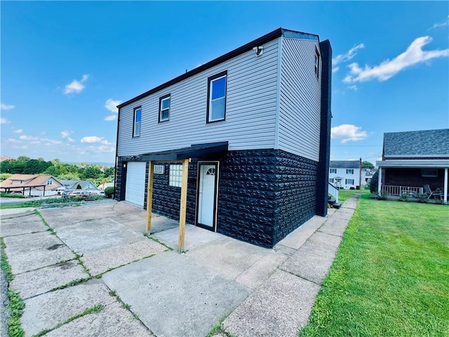 26 Wilmac St, South Union Twp, PA 15401 - view of side of home featuring an attached garage, driveway, and a lawn
