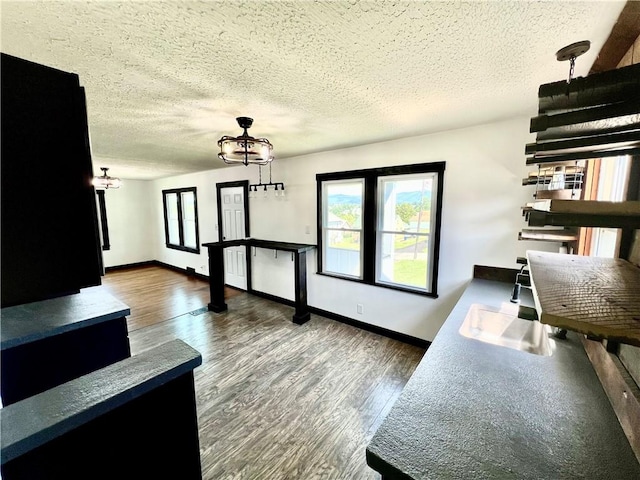 26 Wilmac St, South Union Twp, PA 15401 - living room featuring a chandelier, a textured ceiling, and wood finished floors