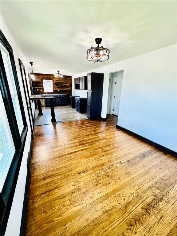26 Wilmac St, South Union Twp, PA 15401 - unfurnished living room featuring wood finished floors and baseboards