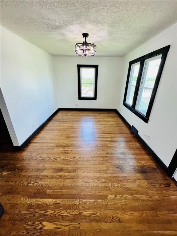 26 Wilmac St, South Union Twp, PA 15401 - empty room with wood finished floors and a textured ceiling