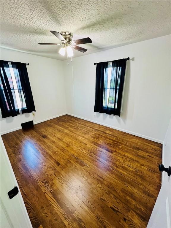 26 Wilmac St, South Union Twp, PA 15401 - spare room featuring a textured ceiling, ceiling fan, and wood finished floors