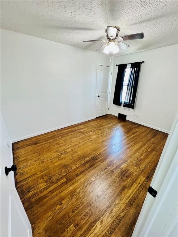26 Wilmac St, South Union Twp, PA 15401 - spare room with dark wood-type flooring, a ceiling fan, and a textured ceiling