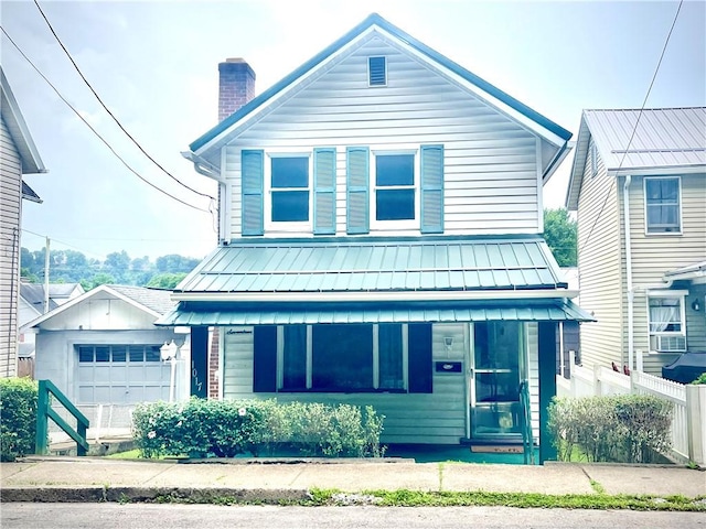 1017 Johnston Ave, Kittanning Boro, PA 16201 - view of front of property featuring a chimney, a standing seam roof, a metal roof, a garage, and board and batten siding