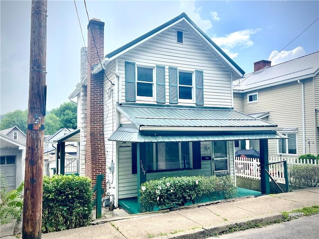 1017 Johnston Ave, Kittanning Boro, PA 16201 - view of front of house featuring covered porch, a chimney, and a metal roof