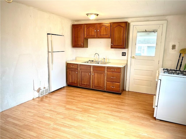 1017 Johnston Ave, Kittanning Boro, PA 16201 - kitchen with white appliances, light countertops, light wood finished floors, and brown cabinets