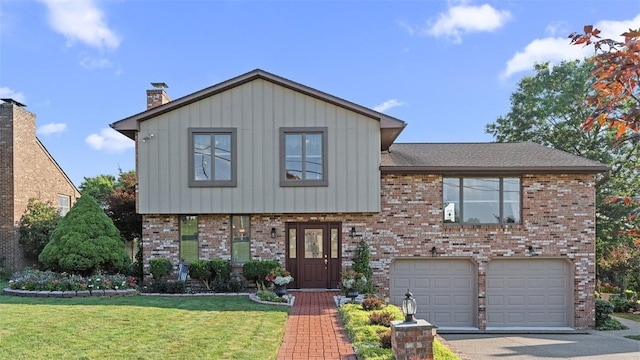 11 Sunnycrest Dr, Cecil, PA 15321 - split level home featuring brick siding, a front yard, driveway, a garage, and board and batten siding