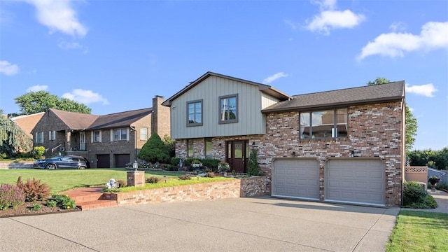 11 Sunnycrest Dr, Cecil, PA 15321 - tri-level home featuring driveway, brick siding, an attached garage, and a front yard