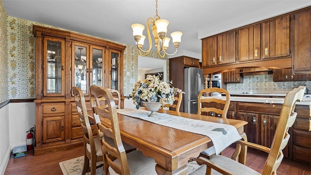 11 Sunnycrest Dr, Cecil, PA 15321 - dining area with dark wood finished floors, a chandelier, and wallpapered walls