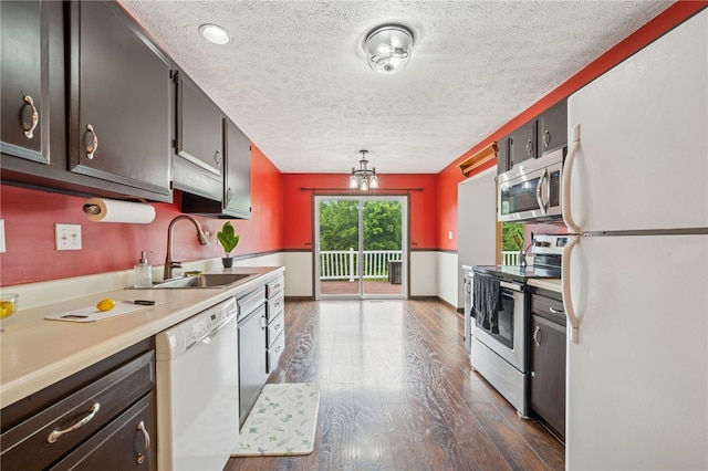 1556 Washington Rd, Washington Twp, PA 15613 - kitchen featuring stainless steel appliances, a textured ceiling, dark wood-style floors, and light countertops