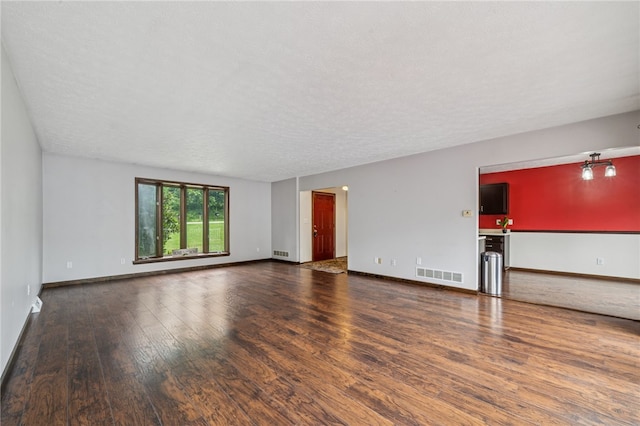 1556 Washington Rd, Washington Twp, PA 15613 - unfurnished living room with wood finished floors and a textured ceiling