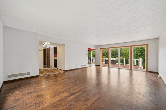 1556 Washington Rd, Washington Twp, PA 15613 - unfurnished living room featuring wood finished floors and a textured ceiling