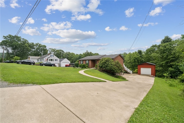 1556 Washington Rd, Washington Twp, PA 15613 - ranch-style home featuring a detached garage, driveway, an outbuilding, and a front lawn