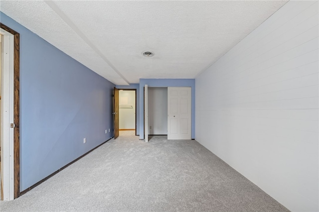 1556 Washington Rd, Washington Twp, PA 15613 - unfurnished bedroom featuring light carpet, a textured ceiling, and a closet