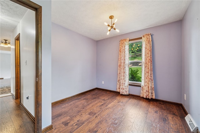 1556 Washington Rd, Washington Twp, PA 15613 - unfurnished room with a chandelier, hardwood / wood-style flooring, and a textured ceiling
