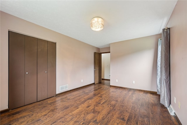 1556 Washington Rd, Washington Twp, PA 15613 - unfurnished bedroom with dark wood finished floors and baseboards