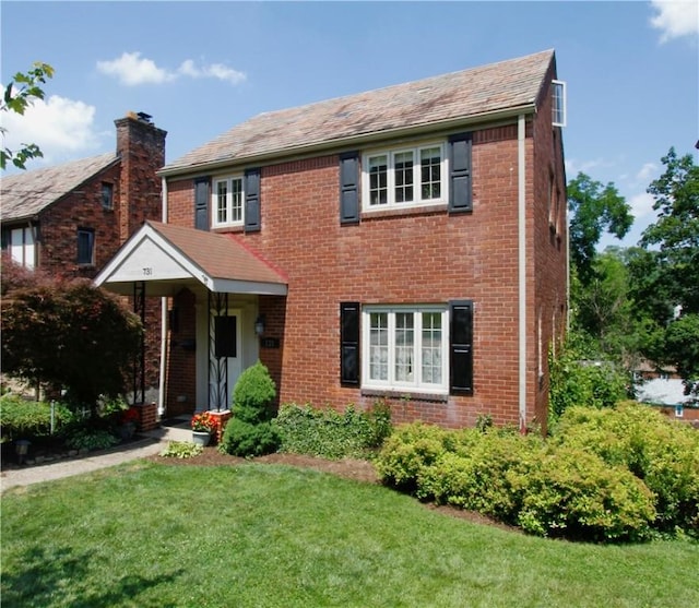 731 Kewanna Ave, Mt Lebanon, PA 15234 - view of front of home featuring a front yard, brick siding, and a chimney