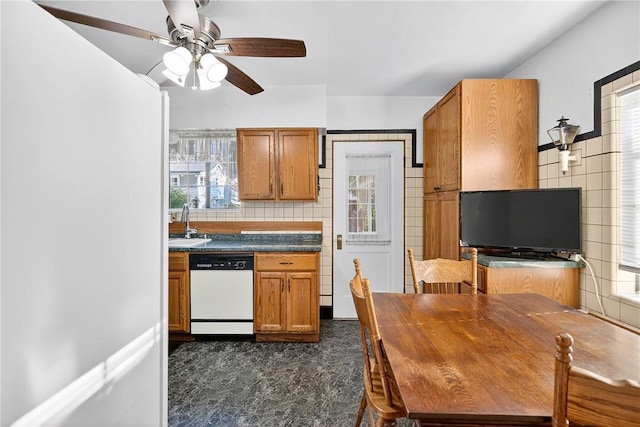 510 7th St, Patterson Heights, PA 15010 - kitchen featuring dishwasher, ceiling fan, brown cabinets, plenty of natural light, and tile walls