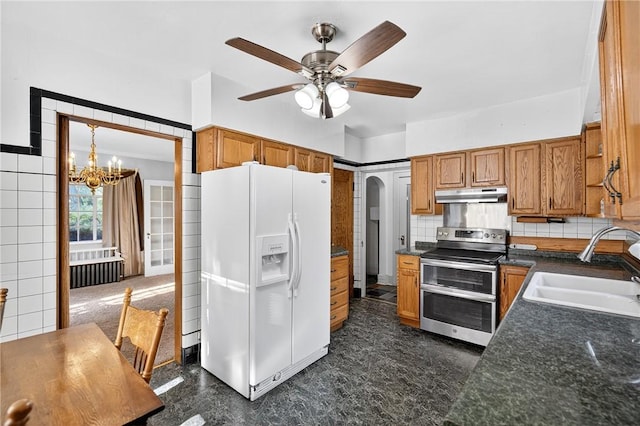 510 7th St, Patterson Heights, PA 15010 - kitchen with white fridge with ice dispenser, double oven range, brown cabinetry, and dark countertops