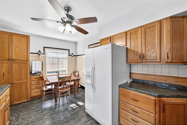 510 7th St, Patterson Heights, PA 15010 - kitchen featuring brown cabinets, white fridge with ice dispenser, a ceiling fan, and dark countertops
