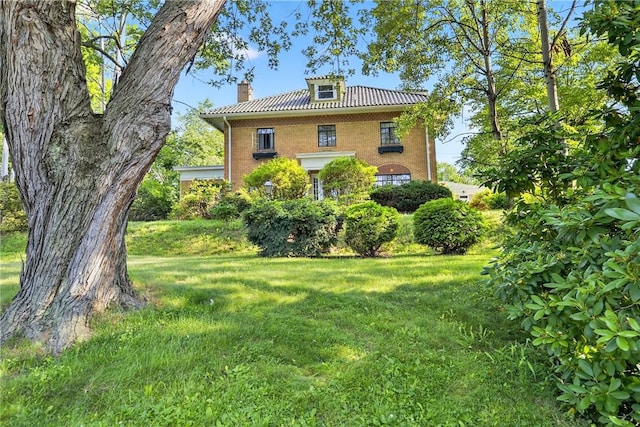 510 7th St, Patterson Heights, PA 15010 - view of side of home featuring brick siding, a lawn, a chimney, and a tile roof