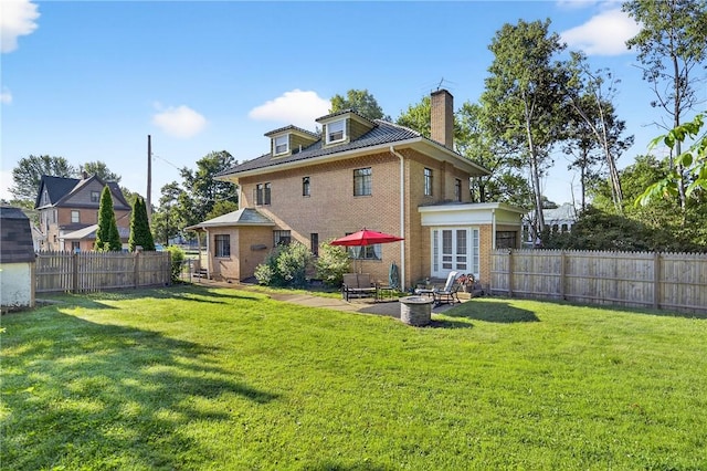 510 7th St, Patterson Heights, PA 15010 - back of property with a chimney, brick siding, a fenced backyard, and a patio