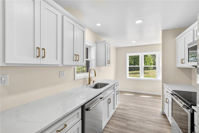 545 Vanderbilt Rd, Dunbar Twp, PA 15425 - kitchen featuring appliances with stainless steel finishes, light wood-type flooring, white cabinets, light stone counters, and recessed lighting