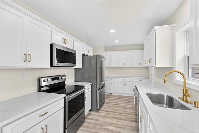 545 Vanderbilt Rd, Dunbar Twp, PA 15425 - kitchen with stainless steel appliances, recessed lighting, white cabinets, light wood-type flooring, and light stone countertops