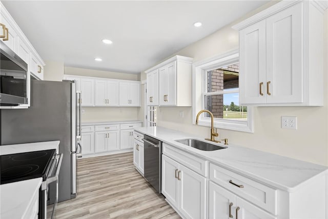 545 Vanderbilt Rd, Dunbar Twp, PA 15425 - kitchen featuring white cabinetry, recessed lighting, appliances with stainless steel finishes, light wood-style floors, and light stone counters