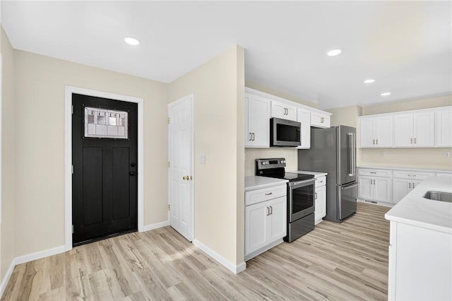 545 Vanderbilt Rd, Dunbar Twp, PA 15425 - kitchen with stainless steel appliances, light wood finished floors, light countertops, white cabinetry, and recessed lighting