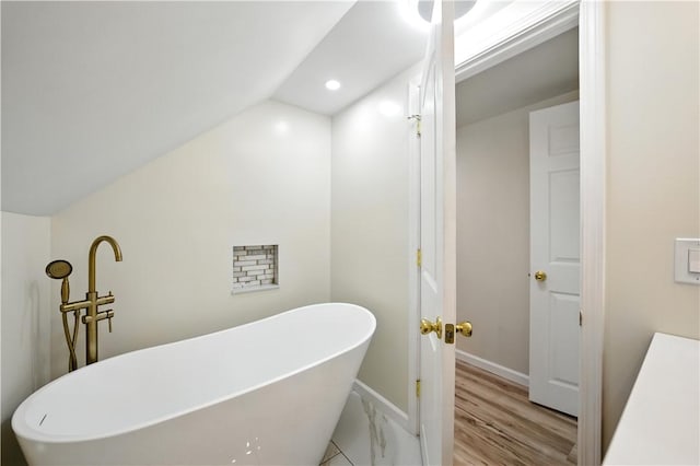 545 Vanderbilt Rd, Dunbar Twp, PA 15425 - bathroom featuring a freestanding bath, lofted ceiling, wood finished floors, and recessed lighting