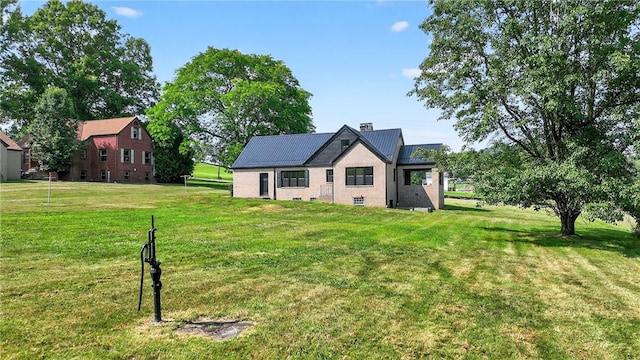 545 Vanderbilt Rd, Dunbar Twp, PA 15425 - back of property featuring a yard, brick siding, and a chimney