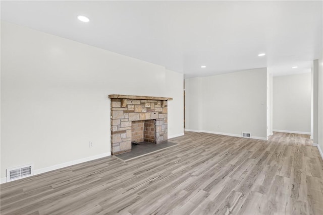 545 Vanderbilt Rd, Dunbar Twp, PA 15425 - unfurnished living room featuring wood finished floors, a stone fireplace, and recessed lighting