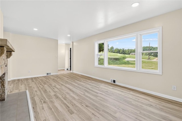 545 Vanderbilt Rd, Dunbar Twp, PA 15425 - unfurnished living room with light wood-style flooring, a fireplace, and recessed lighting