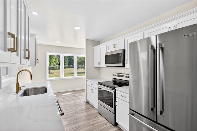 545 Vanderbilt Rd, Dunbar Twp, PA 15425 - kitchen featuring stainless steel appliances, white cabinetry, light stone countertops, light wood-style floors, and recessed lighting