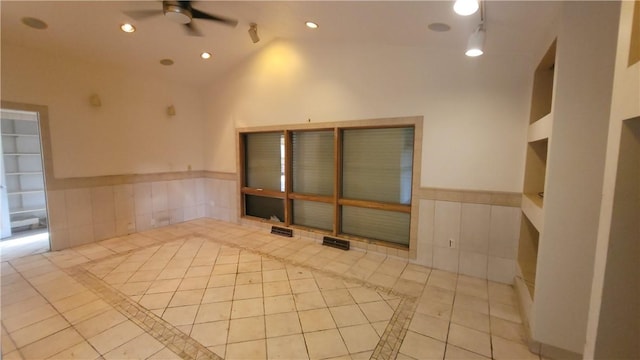 1442 Greensburg Pike, Sewickley Twp, PA 15089 - unfurnished room featuring a ceiling fan, inlaid floor details, built in shelves, tile patterned floors, and vaulted ceiling